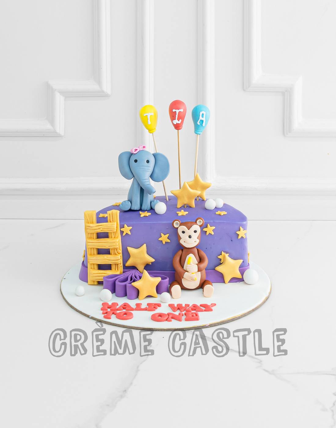6 months Theme Cake in Purple by Creme Castle