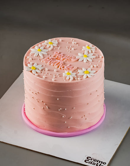 Pink cake with white flowers