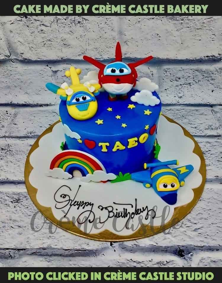 A Cake in the form of planes with planes on top and rainbow on sides ...