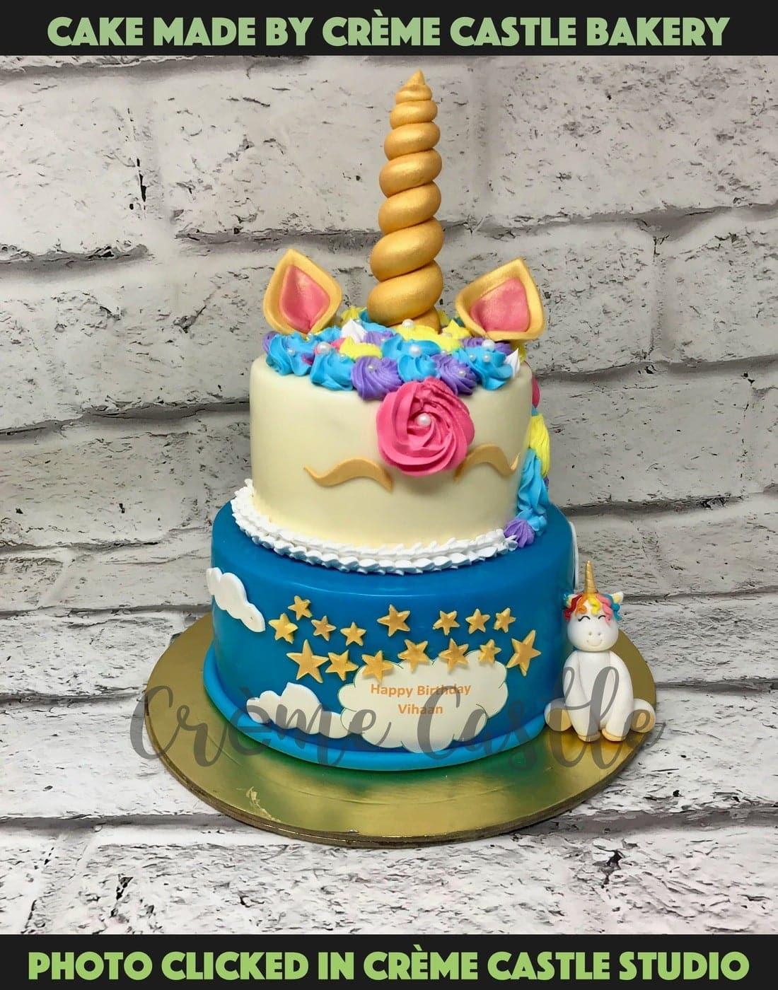 Unicorn cake with golden fondant horn, eyelashes and cream cheese frosting  on festive bokeh background Stock Photo - Alamy
