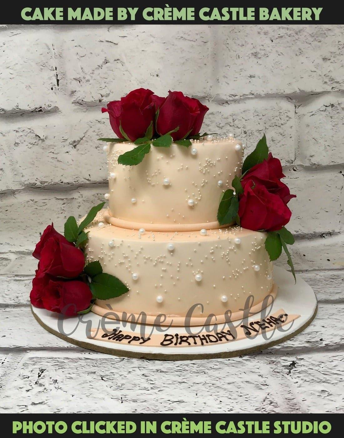 Four-Tier White Wedding Cake with Red Roses