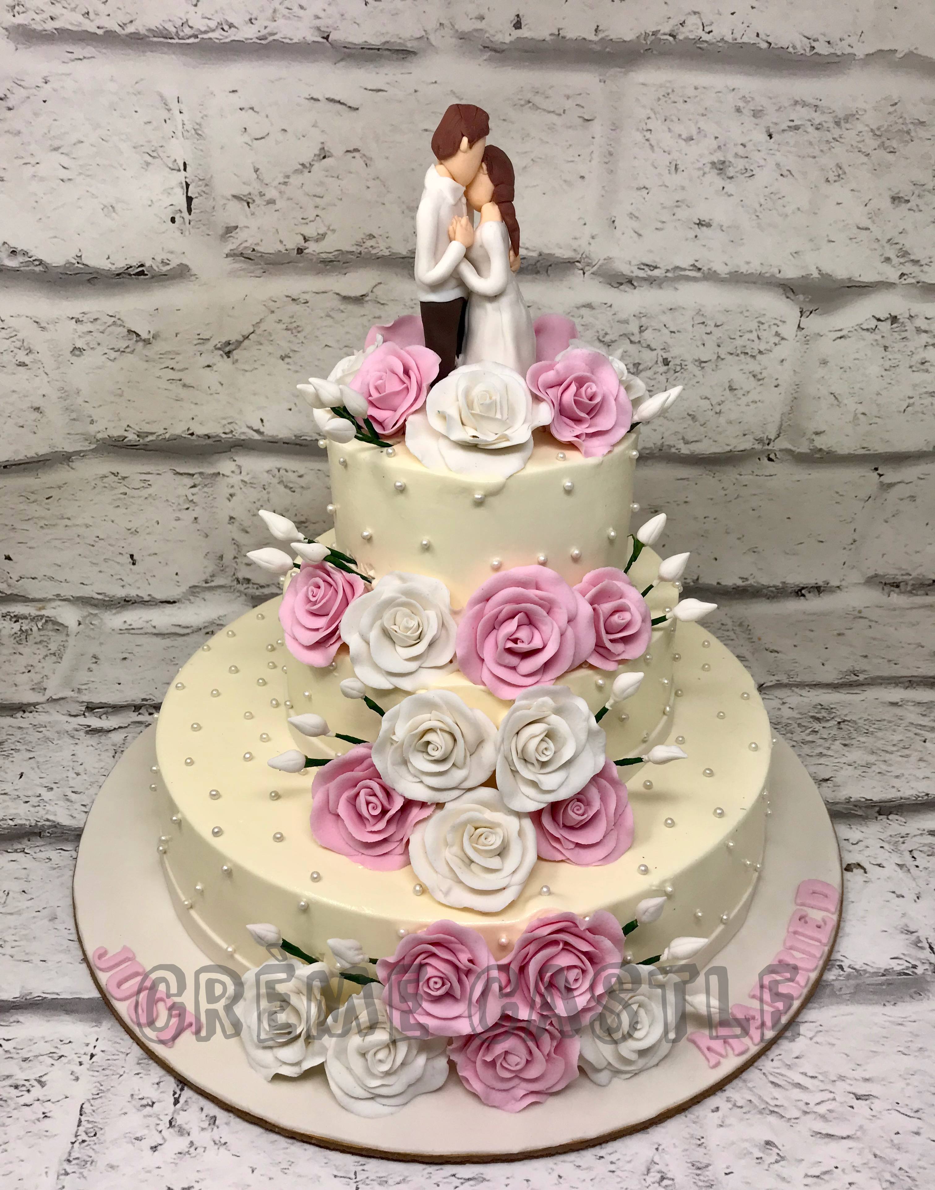 4 Tier pure white wedding cake with couple topper - Gabi Bakes Cakes