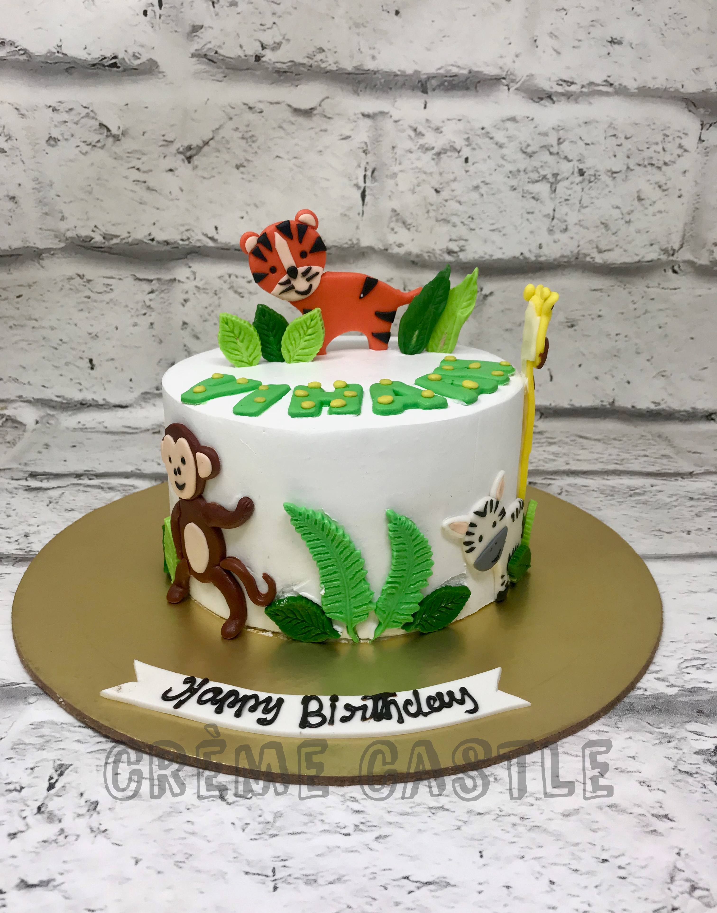 Two Tier First Birthday Cake with Tiger, Elephant and Bunt… | Flickr
